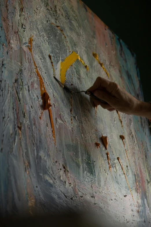 the artist is using a brush to create an oil painting on a piece of paper