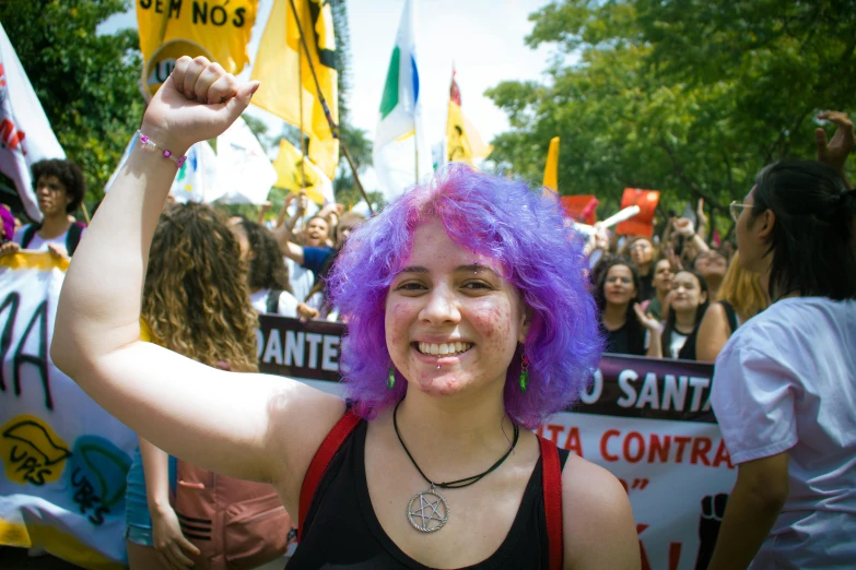 a woman with bright hair and wearing a purple wig