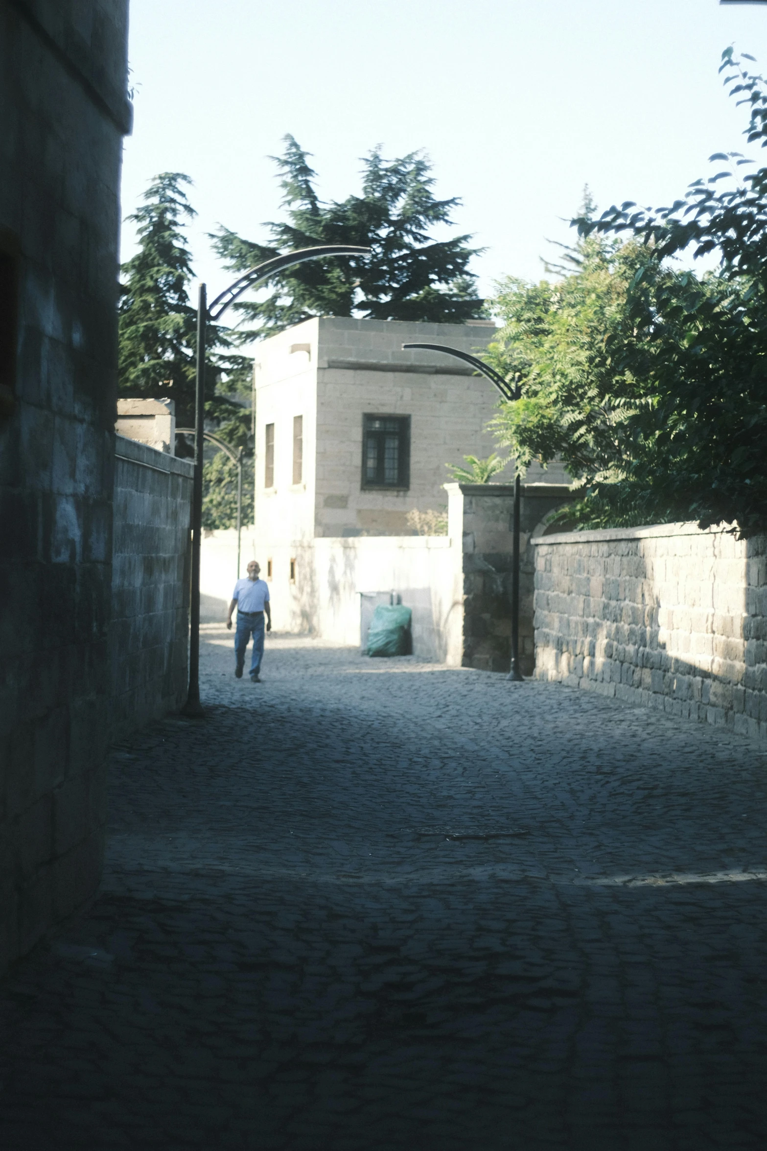 two men are walking down a street near houses