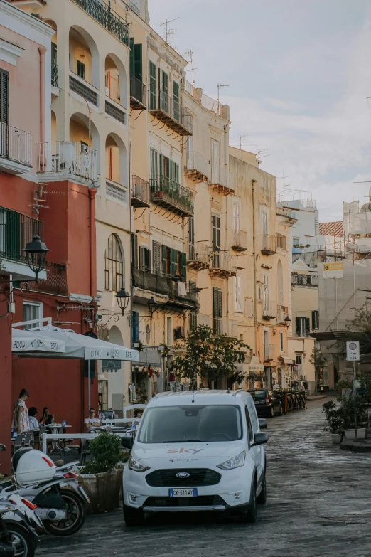 a white car parked in front of a line of building