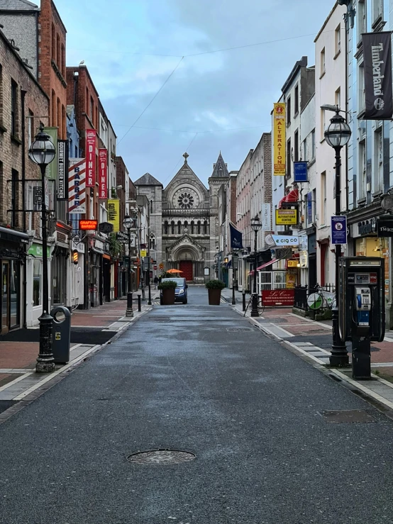 a quiet street lined with retail stores and street signs