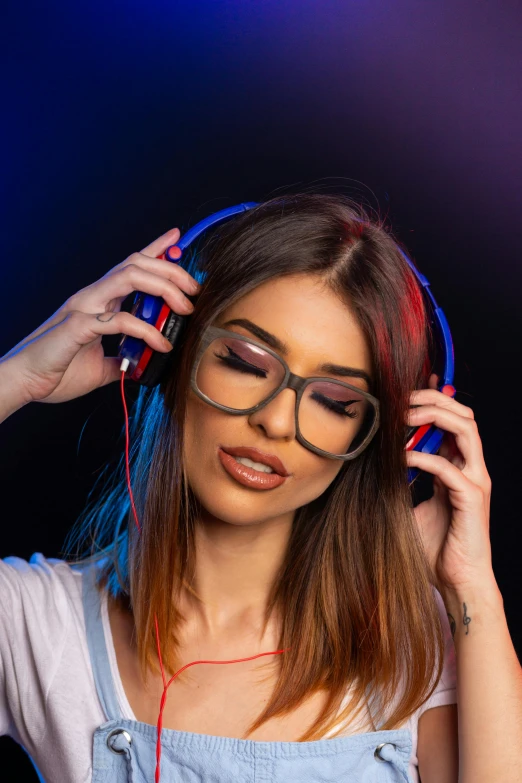 a woman wearing glasses and headphones with a dark background