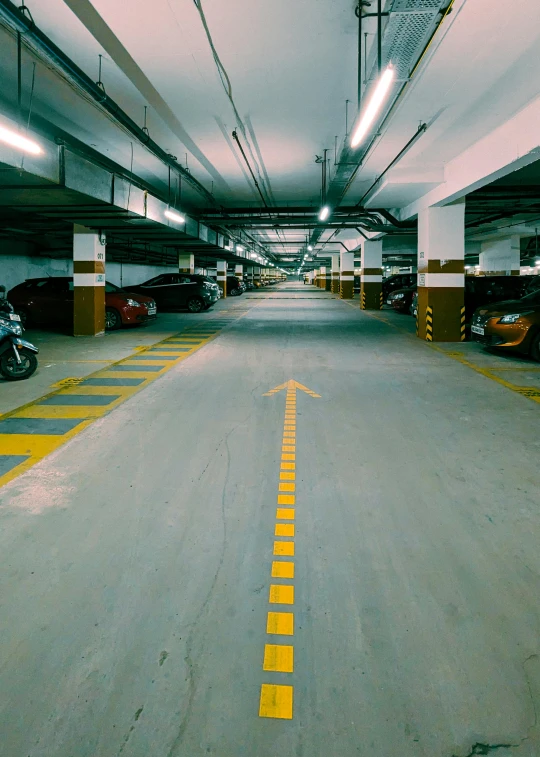 several cars are parked in a lot of parking spaces
