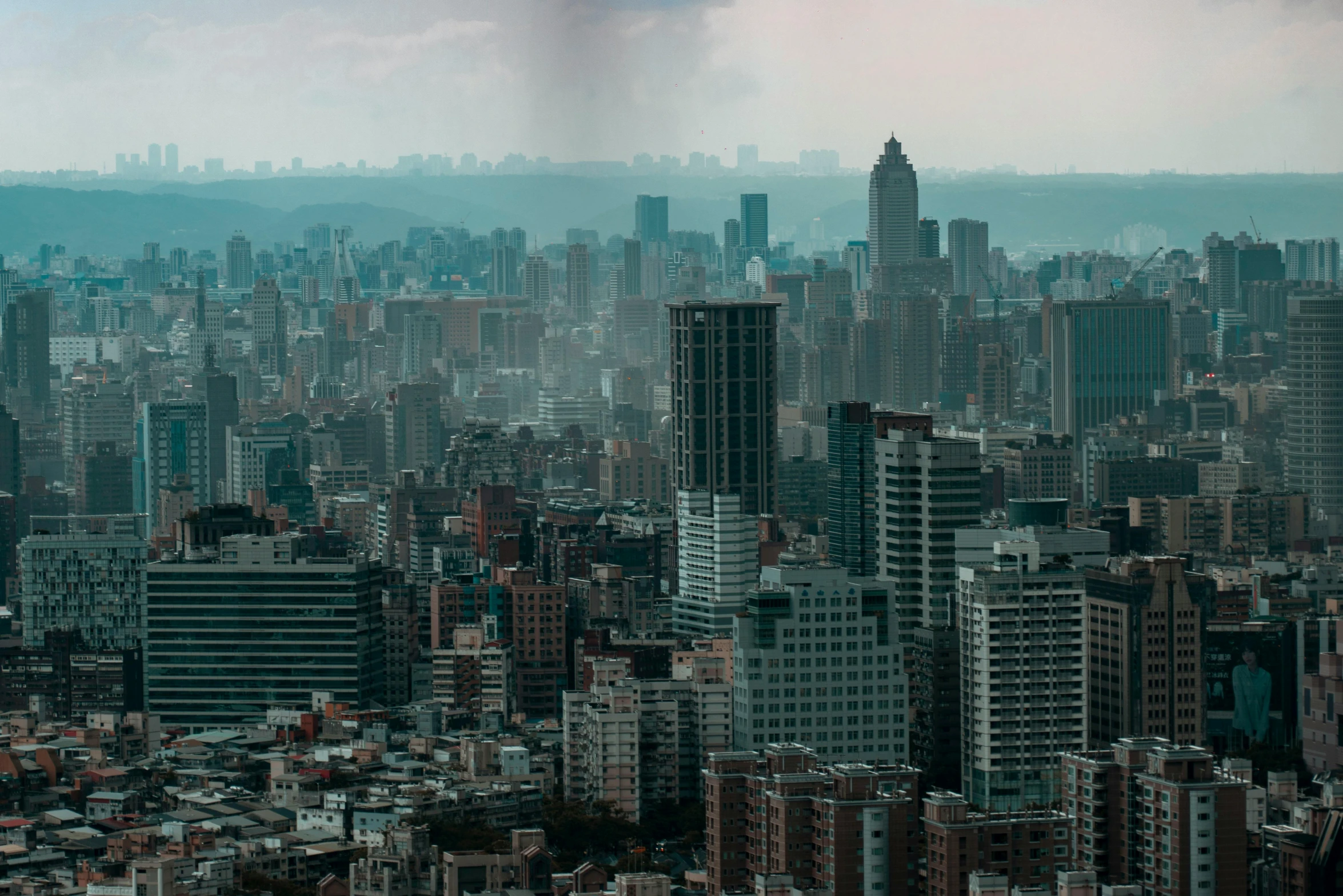 a group of tall buildings that are sitting in the grass