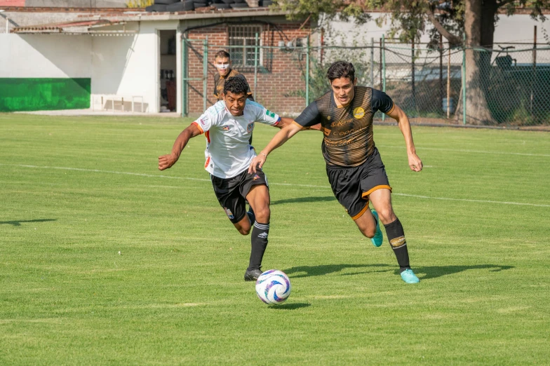 two soccer players playing in a soccer game