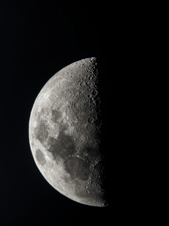 the moon in the dark night sky is very dark