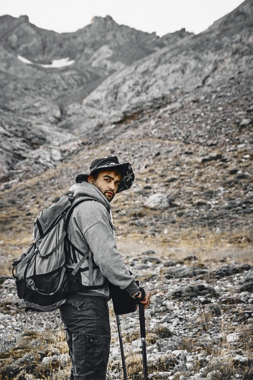 a man standing on top of a mountain holding skis