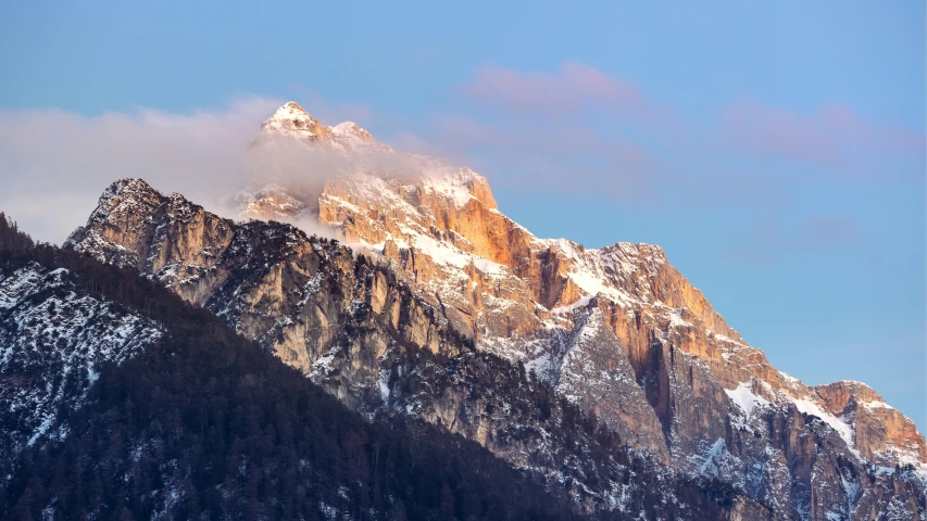 mountains are seen with snow on top of them