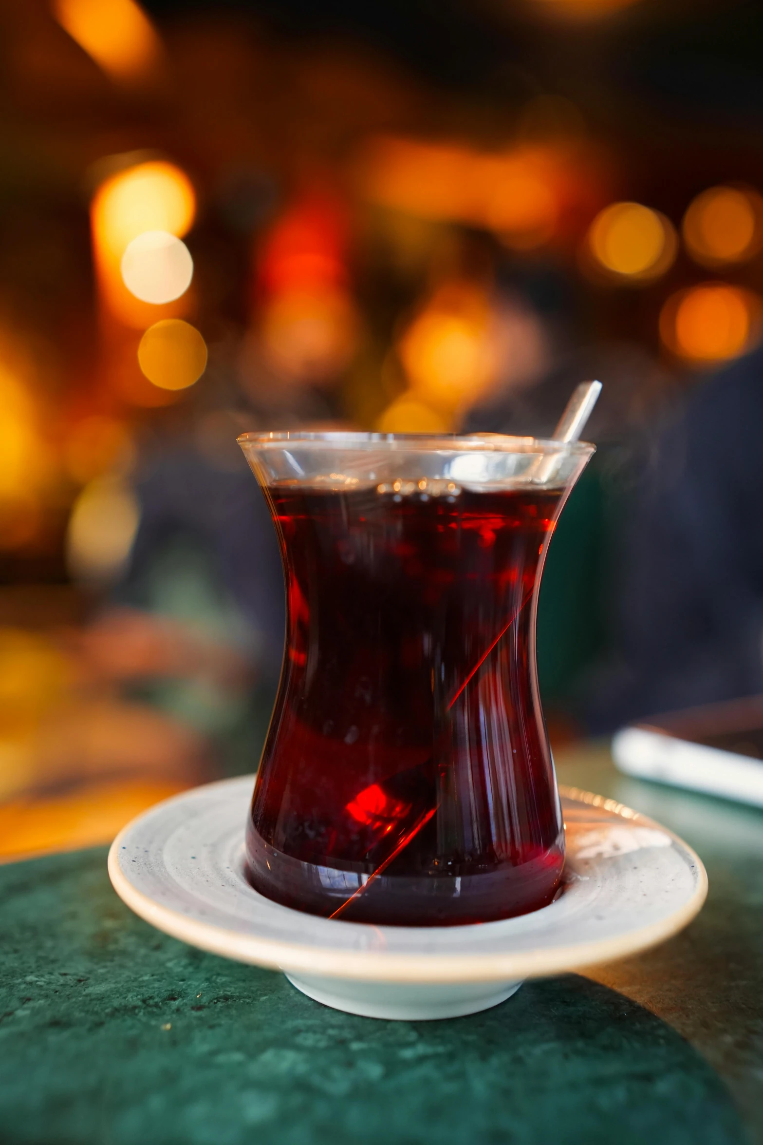 a cup filled with red liquid sits on a plate