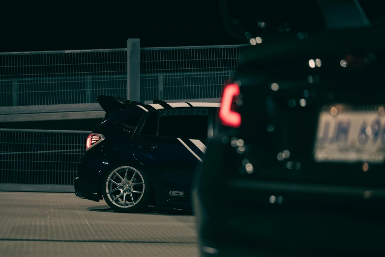 a black car with its doors open parked on the road