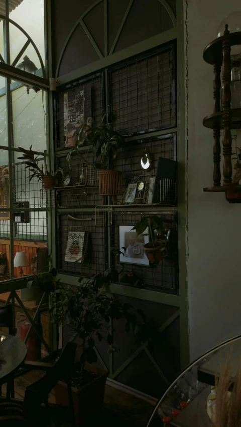 an open window is on a table with some potted plants