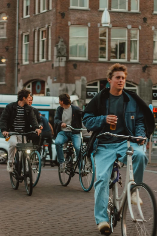 a bunch of people riding bikes on a city street