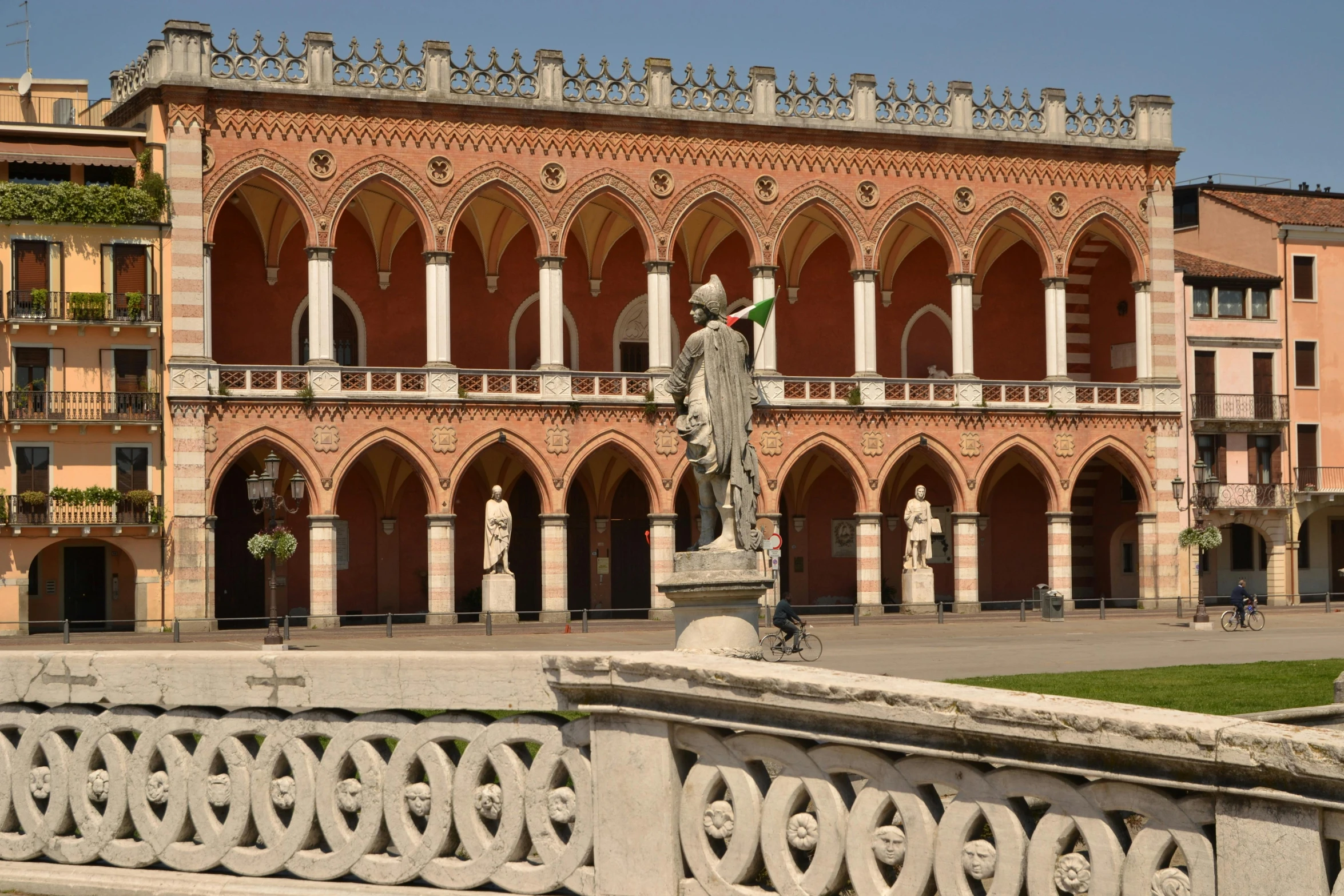 the large brick building has a balcony with decorative balconies