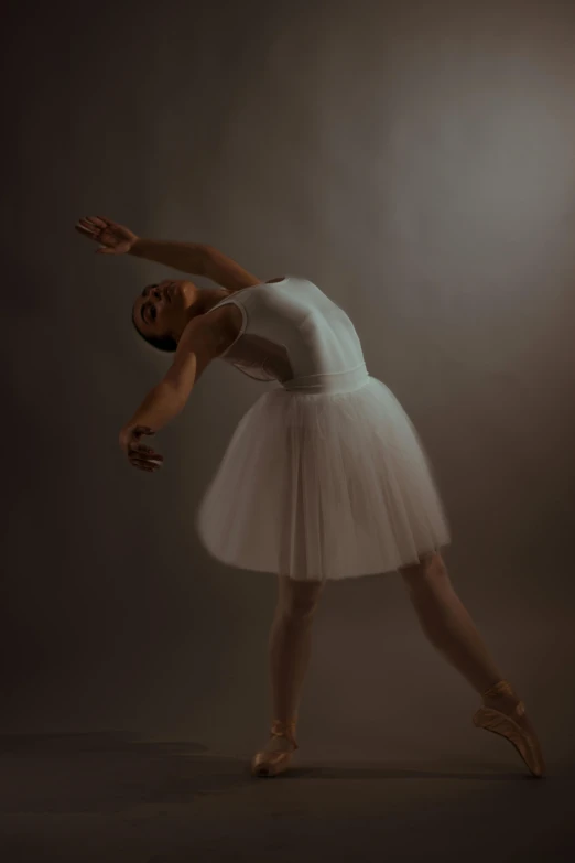 a ballet dancer in a white tutu and gold shoes
