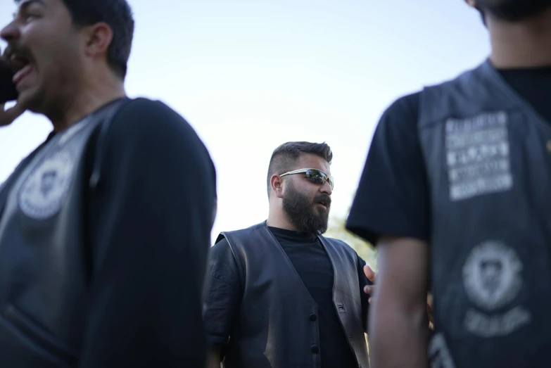 a man with beard wearing sunglasses looking off into the distance