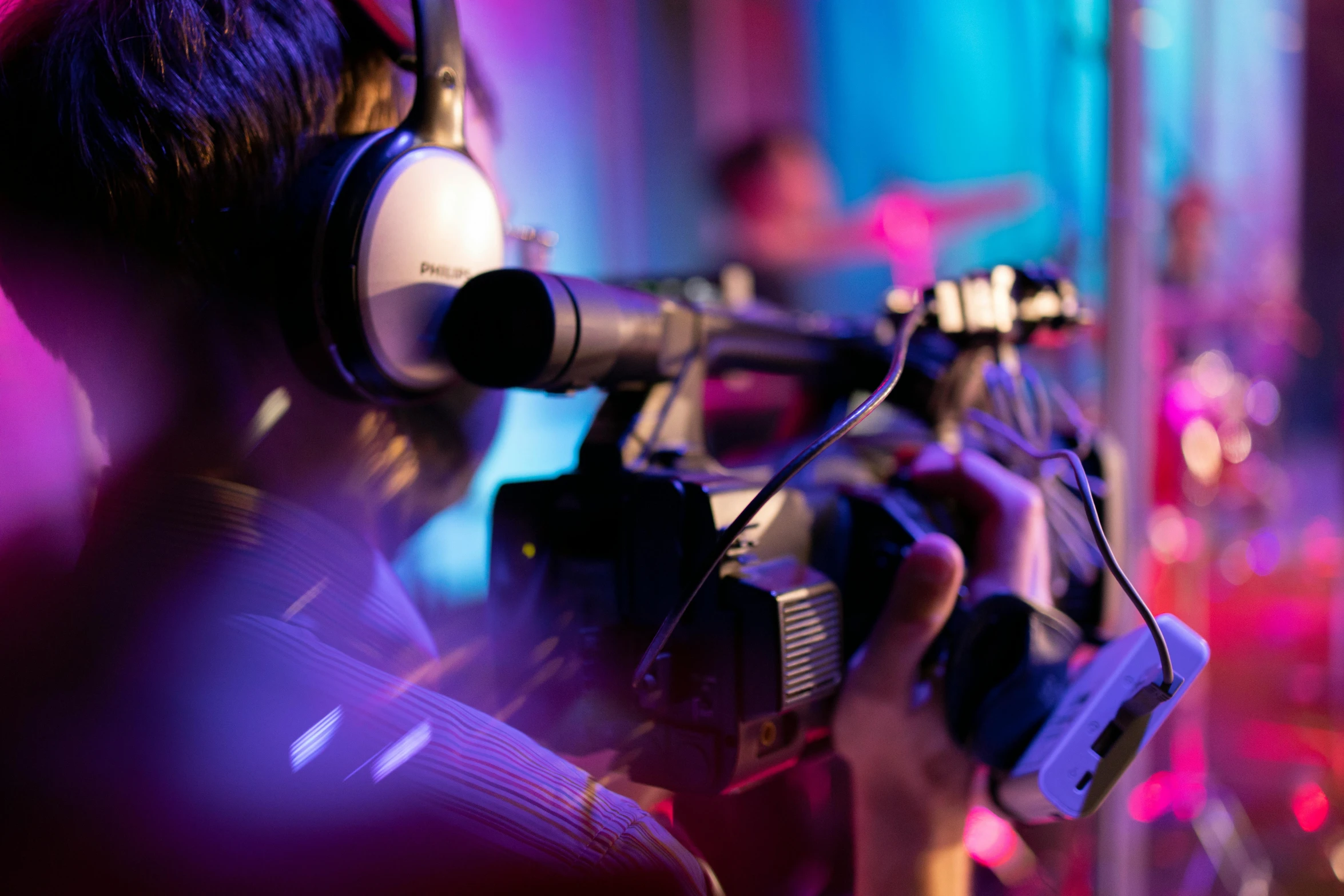 a man in headphones, sitting at a recording studio