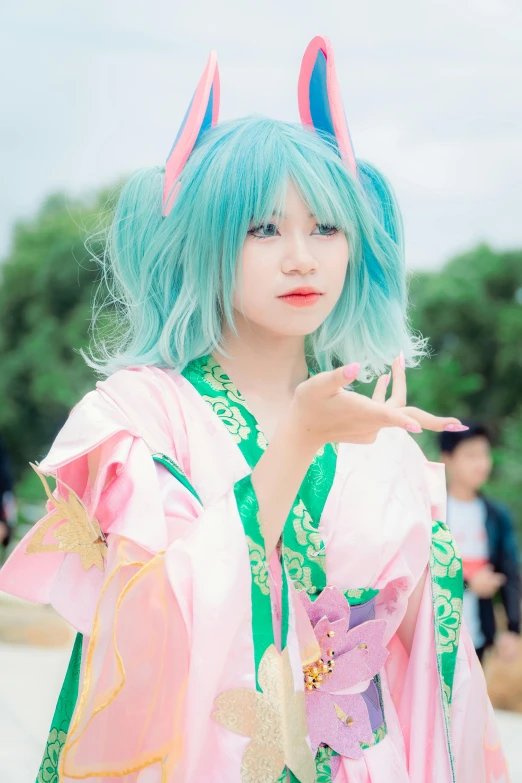 a girl dressed in bright colored costume poses with her fingers up