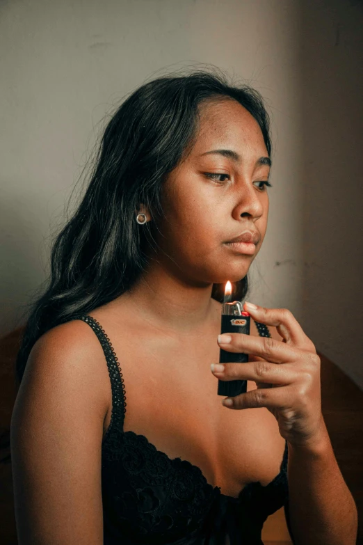 a woman smoking a cigarette while sitting down