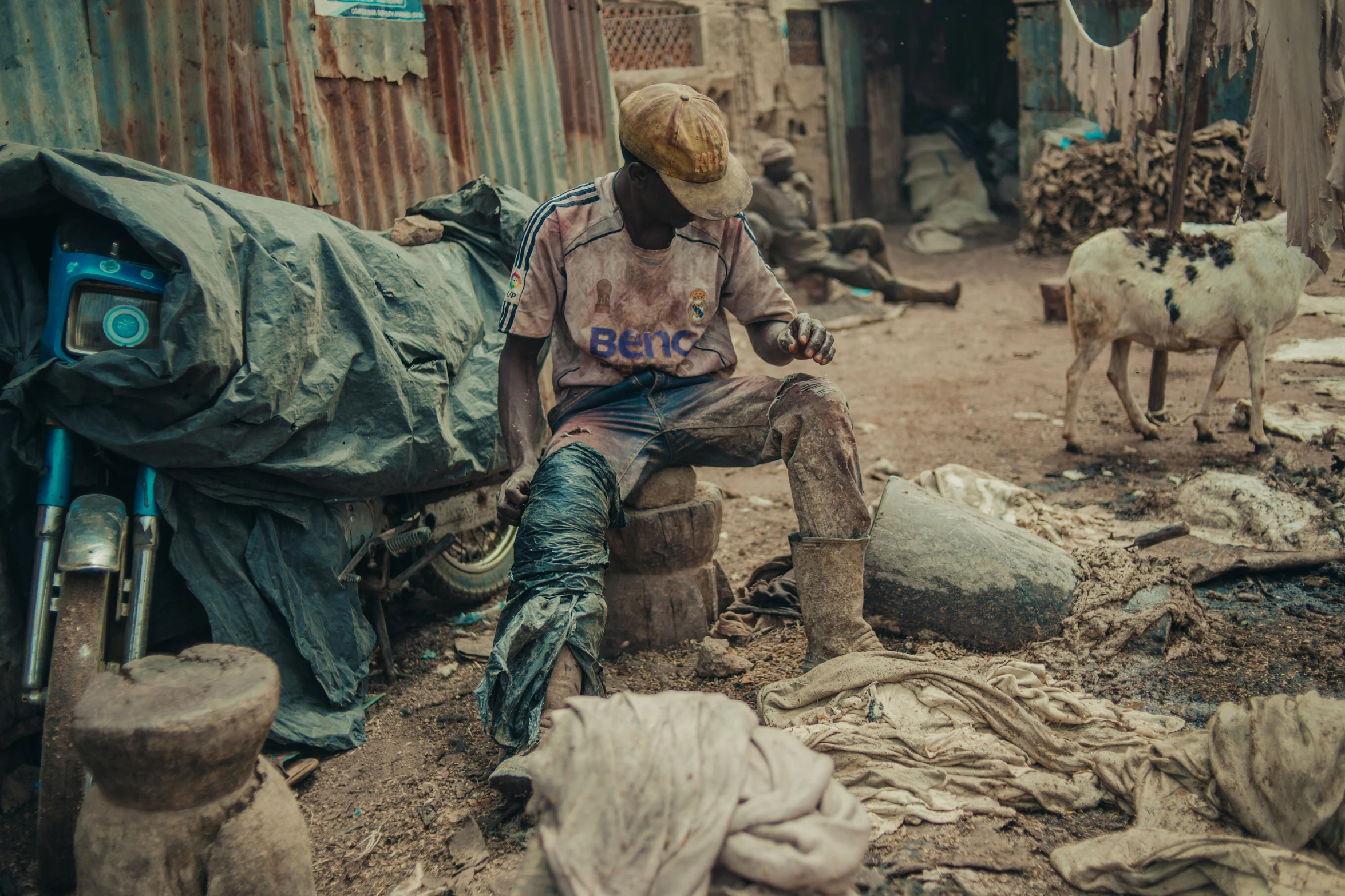 a man sitting in front of an outdoor market