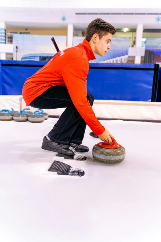 a person on a snow covered surface with a hockey board