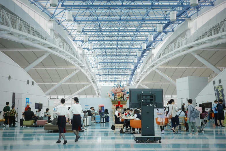 a luggage carousel inside an airport full of people