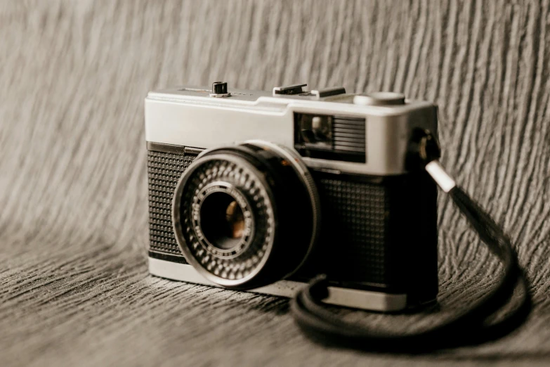 an old po camera sitting on a wooden table