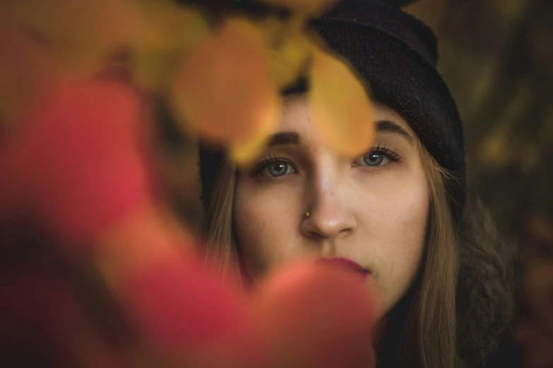 a woman wearing a hat looks through a nch