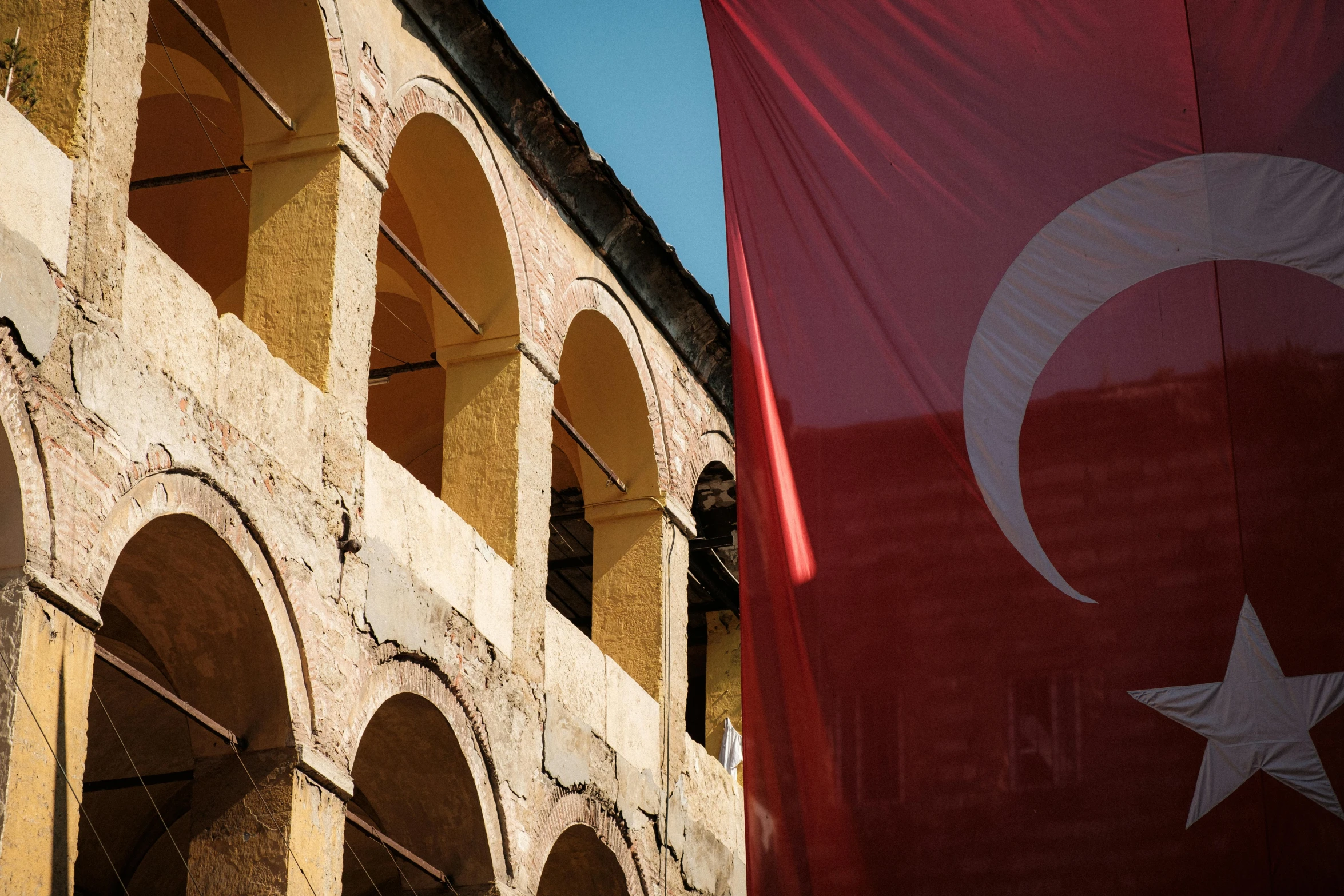 the flag of turkey and an unfinished building are in the foreground