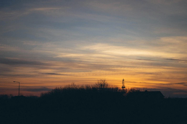 an image of a sunset with clouds over it