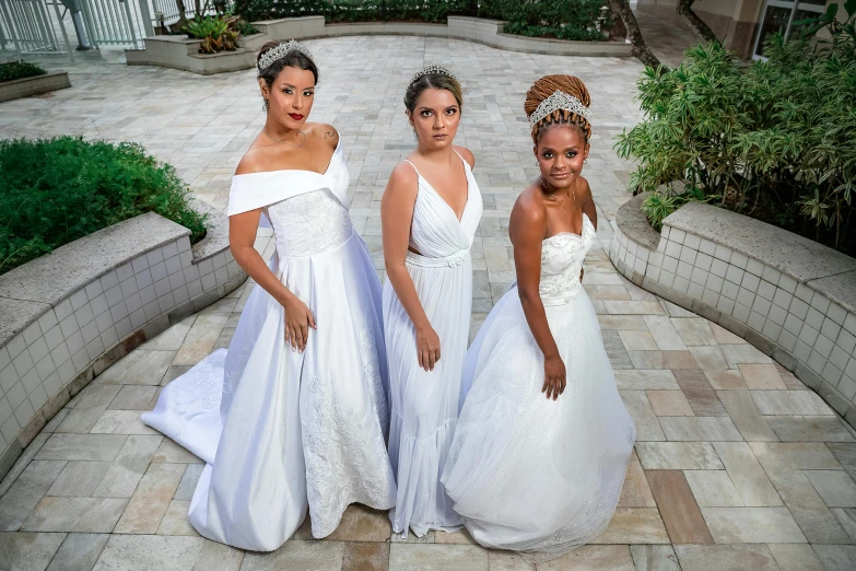 a group of three beautiful women standing next to each other