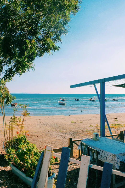 there is a table set on the beach by the water