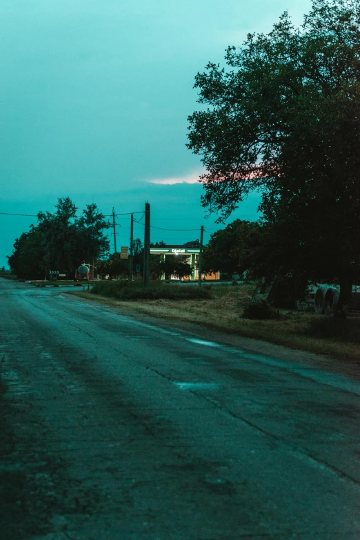 a large long street that is next to a grassy field