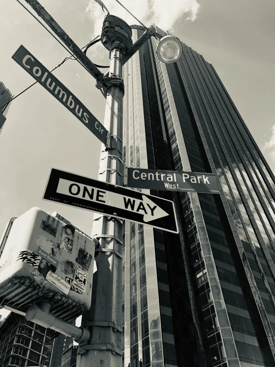 a one way street sign is attached to a pole