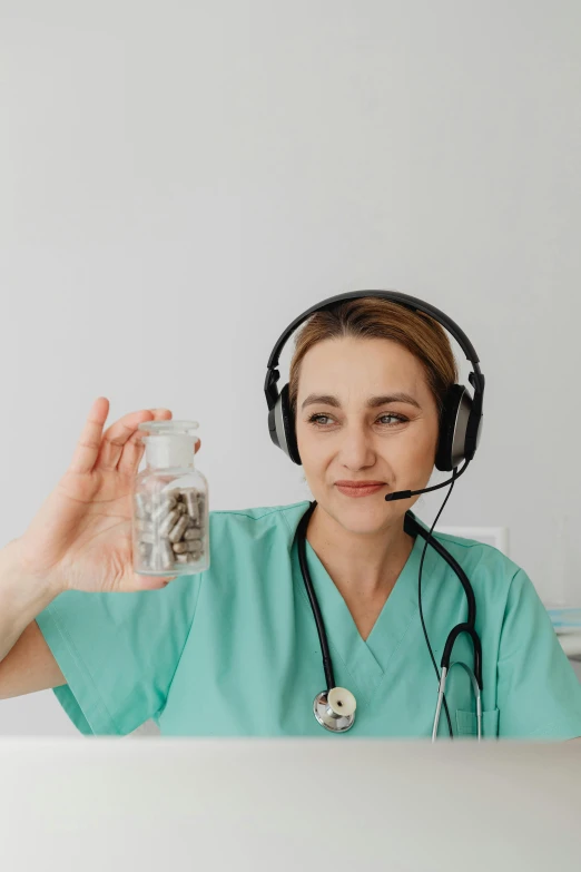 a woman with a nurse outfit on is holding up a jar