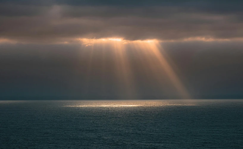 sunbeams from the sky over the ocean