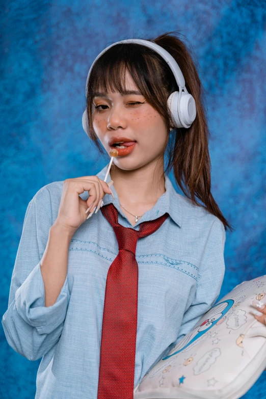 a young woman dressed in glasses and red tie eating