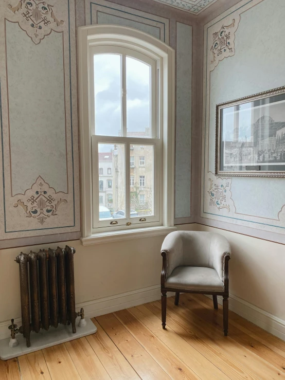 a chair sits in a room by a window