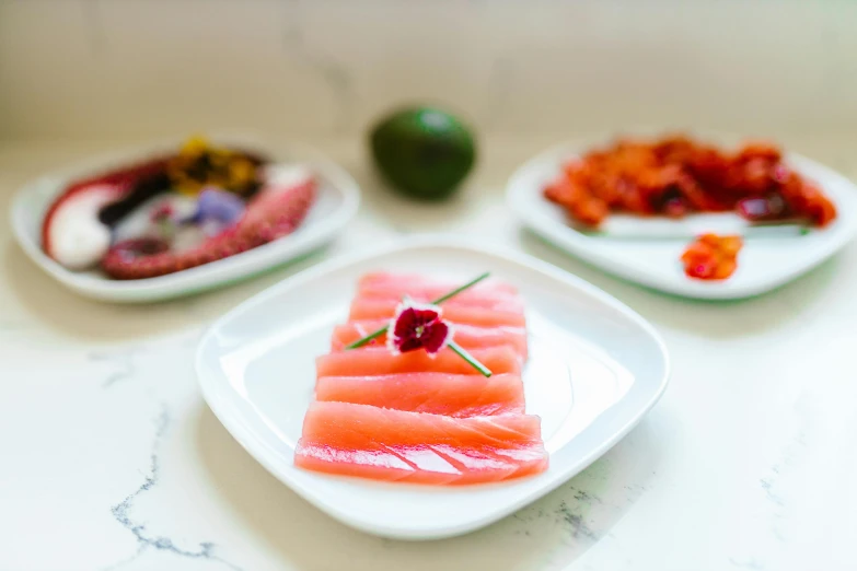 three plates with food sitting on top of a table