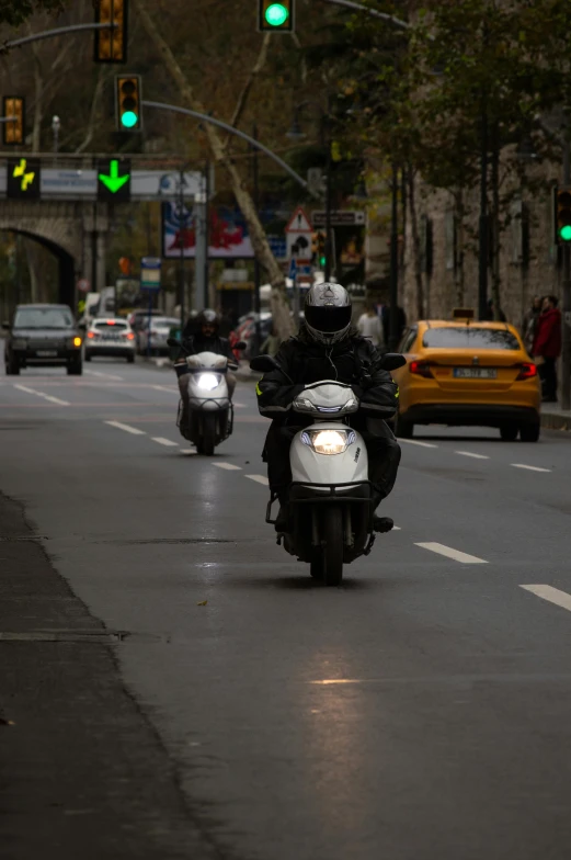 two motorcycles with a man riding them in the middle