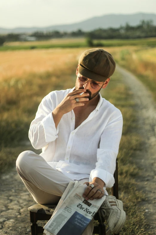 a person sitting in a chair and smoking a cigarette