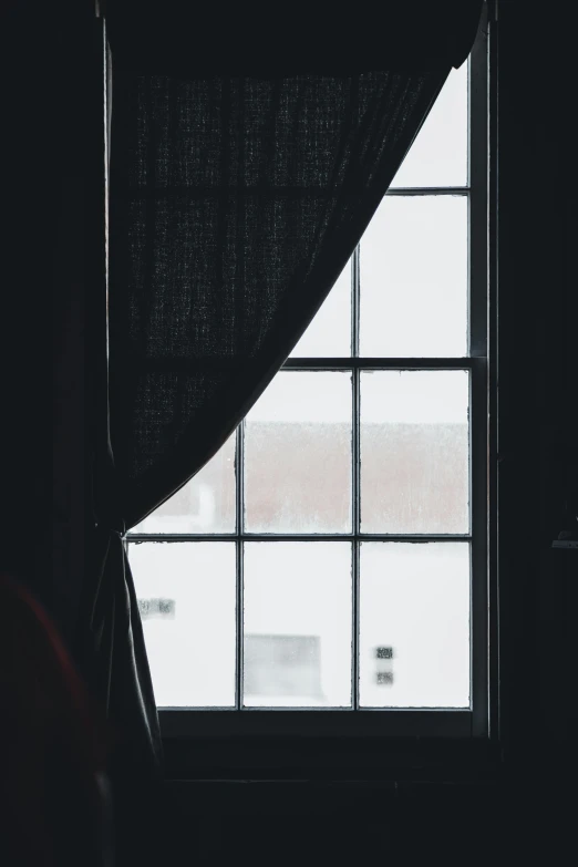 view through the window with curtain to snow outside