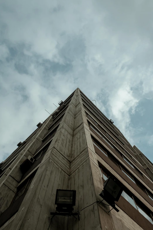 an upside down po of a building under cloudy skies