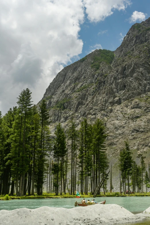 two people out in the water beside mountains