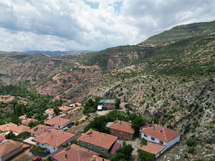 houses surrounded by rocky terrain under a cloudy sky