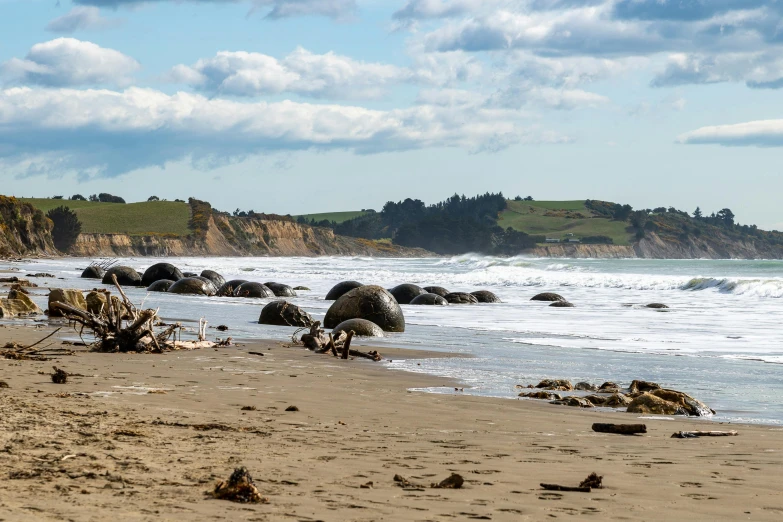 an ocean beach filled with lots of rocky shore