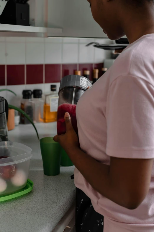 a woman is standing at the counter holding an ipod