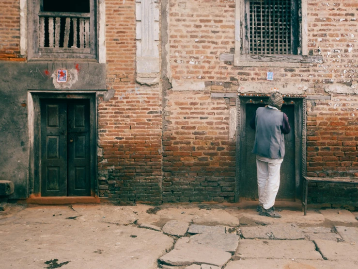 a person is standing outside of an old building