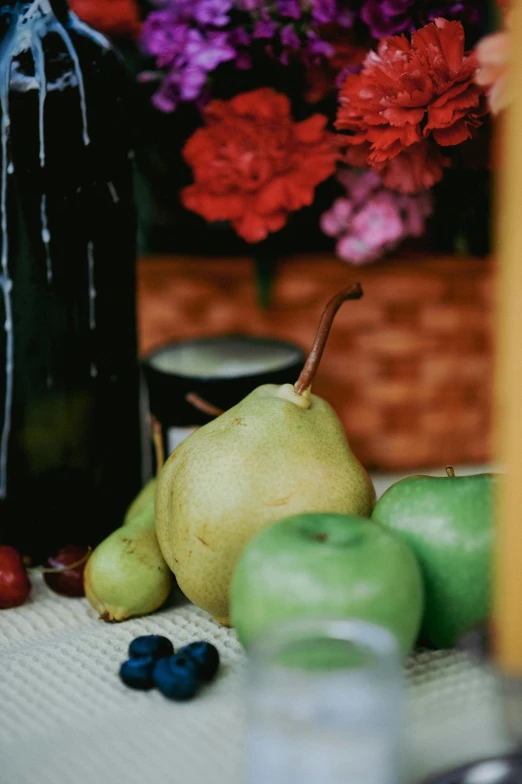 a table with a black jar and some flowers