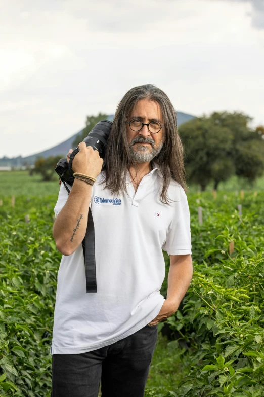 a man in a tie holding a camera in his hand