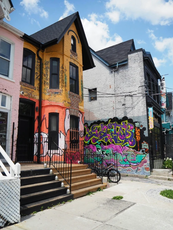 a home painted on the side of a building in an area with stairs to one level